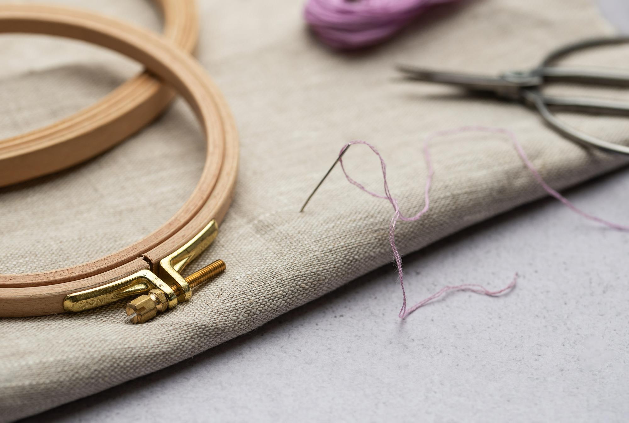 Close-up of hand embroidery on linen with natural threads